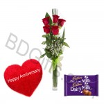 Red roses in vase with heart shape pillow and cadbury dairymilk